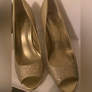 Gold sparkly all over/little stud sparkles on the front. Scratches underneath.